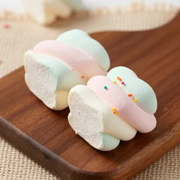 photograph of a marshmallow cube with sprinkles on a dark wooden chopping board, pastel colours, hessian cloth, styled food photography, photorealistic, 4 k