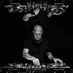 photo of jeff mills djing, slightly inverted colors, black background, rule of thirds, monochrome, low angle