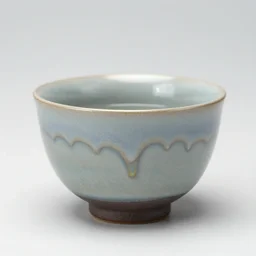 japanese handmade tea cup, drips, dripping glaze, glazed clay, crazed glaze glaze drips, artistic, exquisite, green tea leaves, zen,