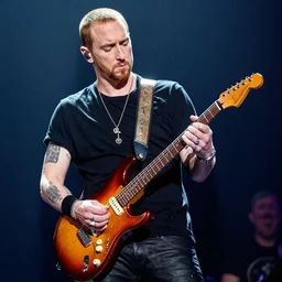 eminem playing an electric guitar on stage