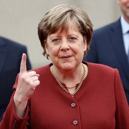 merkel wearing gold chain and throwin gang signs