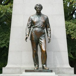 the focal point of the monument is a bronze statue of the king in a seated position on a replica of the manangkhasila asana throne.