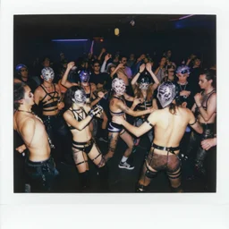 Polaroid photo of a provocative techwear packed busy rundown nightclub, lots of people, males and females breakdancing, variety of sharp sparkly creepy masks, harnesses and garters, some people holding drinks or have robot limbs or have cybernetic mods, tattoos and piercings, retrofuturism, brutalism, cyberpunk, sigma 85mm f/1.4, 15mm, 35mm, tilted frame, long exposure, 4k, high resolution, 4k, 8k, hd, wide angle lens, highly detailed, full color, harsh light and shadow, intoxicatingly blurry