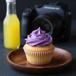 dslr food photography of a lemon cupcake, on a dark wooden plate, dark background, with purple lemon creme topping and a bottle of lemon sauce on the side, macro shot, hasselblad, 1 0 0 mm f 1. 8, dynamic lightning