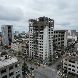 A broken down cityscape; abandoned buildings and streets