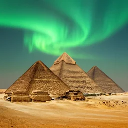 The great pyramids with green aurora lights in the sky absolutely stunning