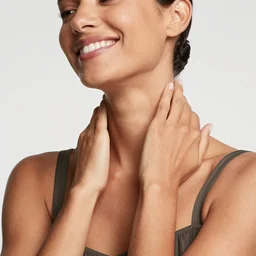 olive skinned female model in her thirties wearing a dress, happy, focused on her neck, photo realistic, extreme detail skin, natural beauty, no filter, slr, golden hour, 4 k, high definition, selfie