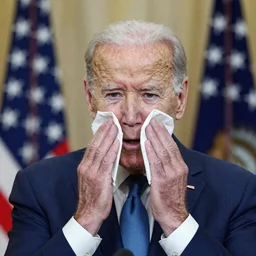 joe Biden wiping his cheeks clean with paper