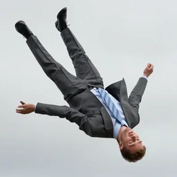 Warren Clarke as Dalziel wearing a gray suit and necktie falling from the sky