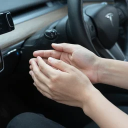 holding a car with his hands