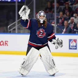 ice hockey goalie waving to his beautiful sister in the stands