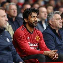 akshay kumar sitting in a manchester united game crowd hd photorealistic