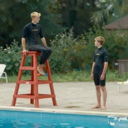 a blond lifeguard in a wetsuit watching the pool vigilantly. Kuvshinov ilya. Repin. Phil Hale. Masterpiece. Rule of thirds