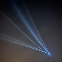 bright lasers shooting through a dark cloud