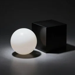 photo of a white ball and a black cube