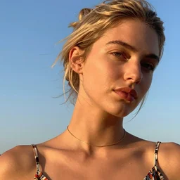vintage photograph of an olive skinned female model with strawberryblonde hair in her twenties, her hair pinned up, wearing a designer top and one thin gold chain necklace, looking content, focused on her neck, photo realistic, extreme detail skin, natural beauty, no filter, slr, golden hour, 4 k, high definition, selfie