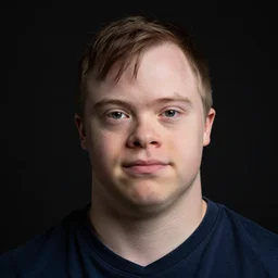 portrait of down syndrome paul denino, sharp focus, 4 k editorial photograph, soft lighting, black background