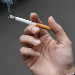Close-up of thin soft hand holding cigarette with smoke, hyper realistic, high details, photo, super resolution