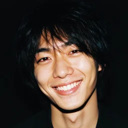 very old photo of joji grinning at the camera with his head being slightly tilted to the right, lots of grain, red reflection in eyes, dark pitch black background, in te style of the album ballads 1.