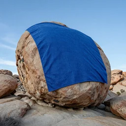 a boulder in Joshua Tree completely coveted in blue felt fabric