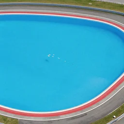 f 1 racetrack over pools of bright blue water, birds eye view