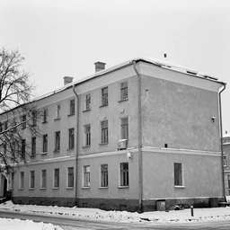 A high-resolution black and white film photograph of details with 35 mm f/12 lens of Soviet-era buildings in Belarus while it snows
