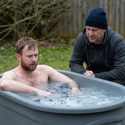 Adam buxton and louis theroux have an ice bath, outside, cold, odd, depth of field, photorealistic