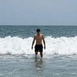 the last man is standing hip deep in wild ocean waves