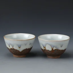 a pair of japanese handmade tea cups, drips, dripping glaze, glazed clay, crazed glaze glaze drips, artistic, exquisite, tea leaves, zen,
