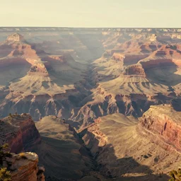 a retrowave style artwork of grand canyon national park, a land of the dead, divine, hazy, volumetric lighting, spacetime bending, very detailed, serene, gold accents, washed out colors, beautiful artwork, master level composition, raytracing