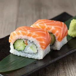 a joyful whole salmon in a sushi roll with cucumber and wasabi