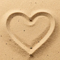 macro of grains of sand forming a heart