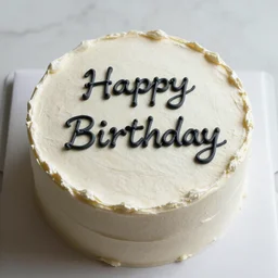 A cake with the phrase 'Happy Birthday' written on it with cream