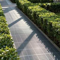 Hedge pathway with metal grate flooring with rugs