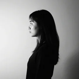 a side profile portrait of a woman. ultra contrast. black and white. centered in frame.