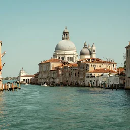 a serene landscape of venice, green river, on the bank is the domed church, by william turner
