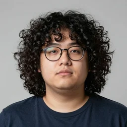 a chubby man with glasses and shoulder length incredibly curly!! black hair