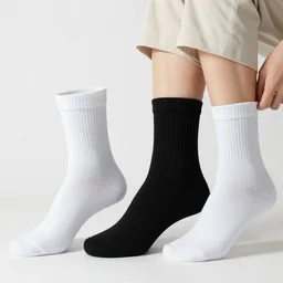Photograph of Albert Einstein having trouble choosing whether or not to wear white socks or black socks