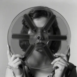 a haunting image of a young starlet with x's cut into the negative, from a lost silent film, occult symbolism, black and white, film reel, a film from the 1 9 1 0 s