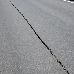 a thin oblong crack in the road very detailed, hd
