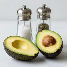 two halves of an avocado as salt and pepper shaker