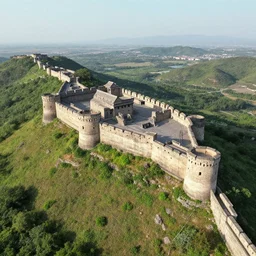 aerial view of an ancient fortress from above on a hill by the ocean shaped exactly like the punisher symbol detailed