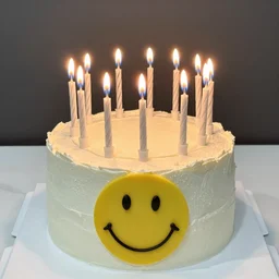 a birthday cake with a melting yellow smiley face and forty candles