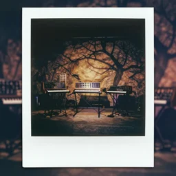 1980s polaroid colour flash photograph of a rock stage with 80s modular synthesizers