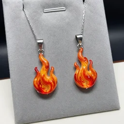 jewelry design, jewelry display, a pair of pendants in the shape of a flame