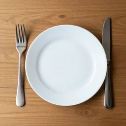 a fork, a plate and a knife on a wooden table, top - down, stock photo