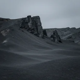 a gloomy region, with jagged rock formations rising out of the bleak, desolate lowlands.