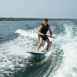 a man barefoot water skiing behind a boat