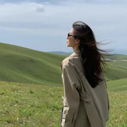a girl enjoying the wind in the edge of a hill, beautiful landscape, aesthetic