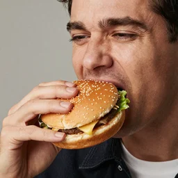 High resolution real photo of a hamburger eating a man